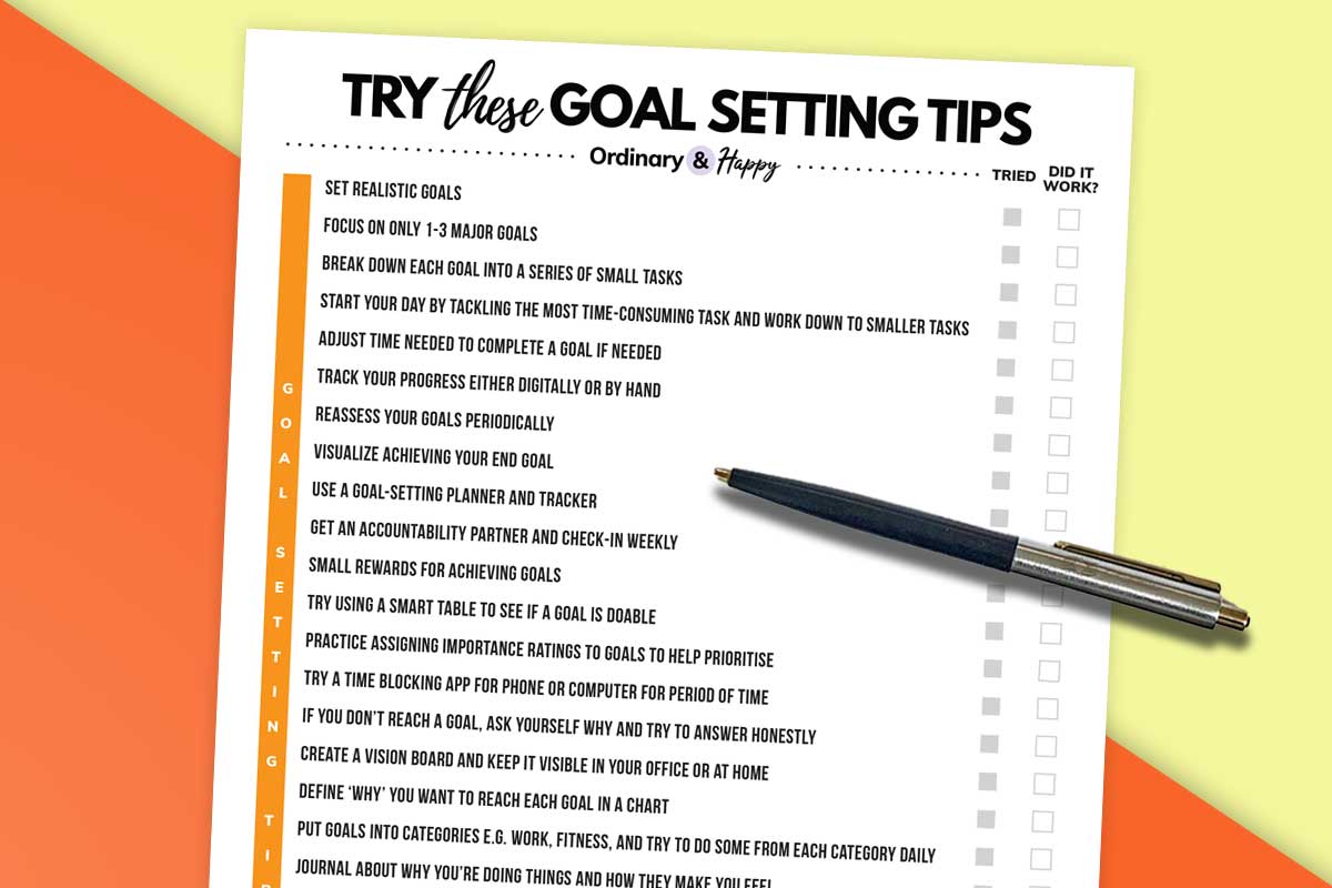 a goal setting tips list laid out on a colored background with a pen