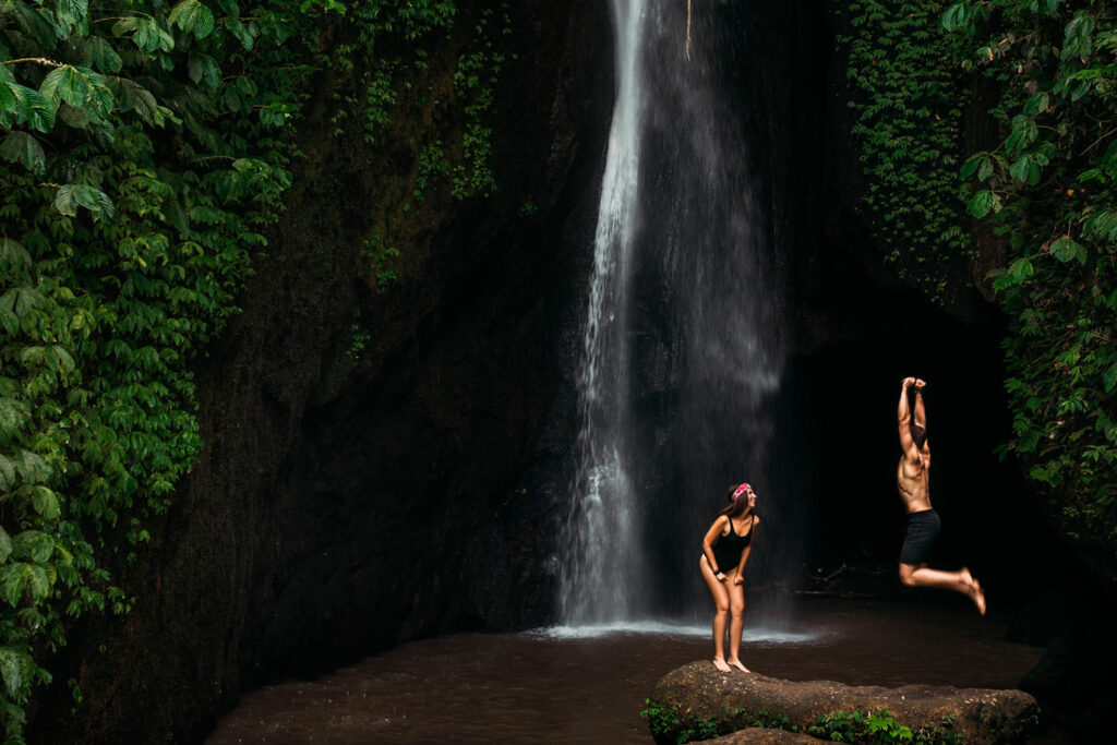 Couple having fun in front of a waterfall.