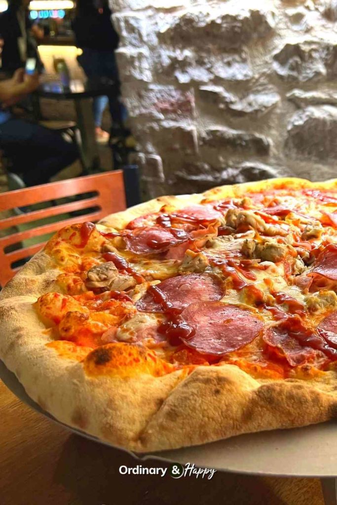 Large meat-lovers pizza.