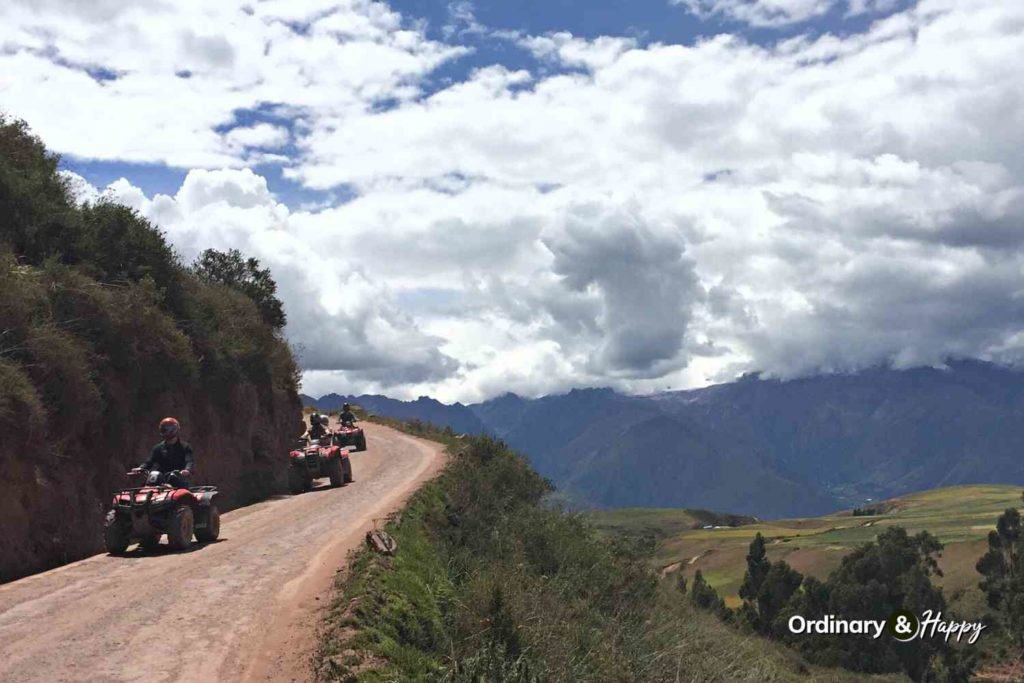 ATV riders by a mountain.