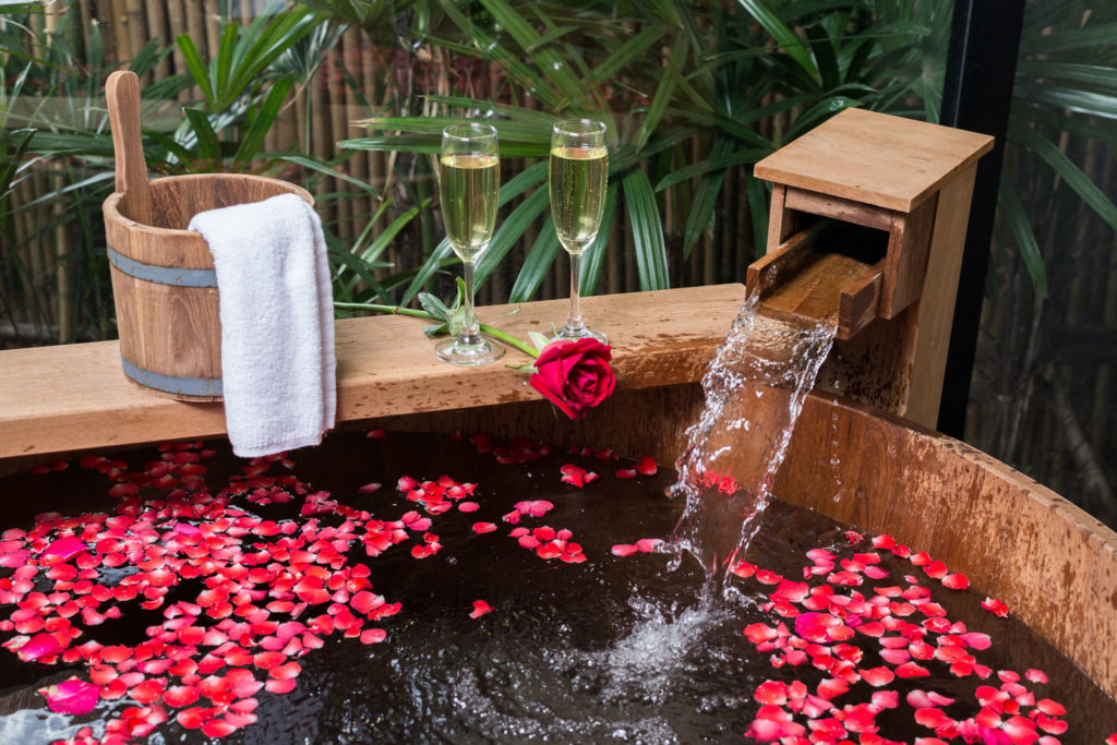 50th birthday idea: champagne and hot tub with rose petals.