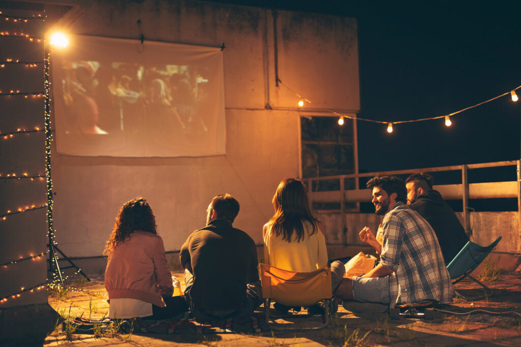 Watching a movie on the projector outdoors.