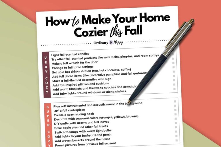 partially visible list of ways to make your home cozier this fall on a white page next to a pen placed on a red and green background