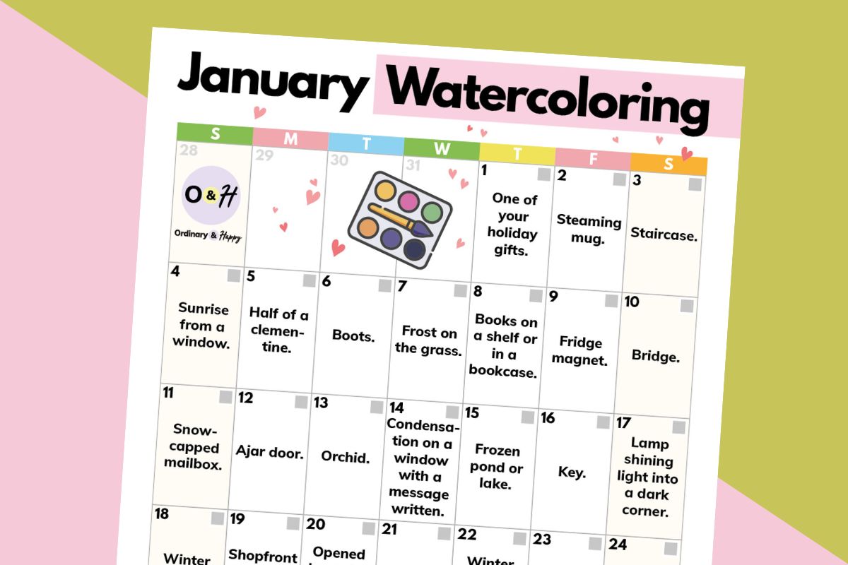 january watercoloring prompts calendar displayed on an orange and pink backdrop