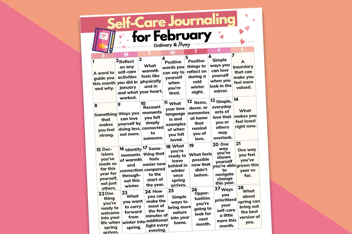self-care journaling ideas calendar for february displayed on an orange and pink-red backdrop