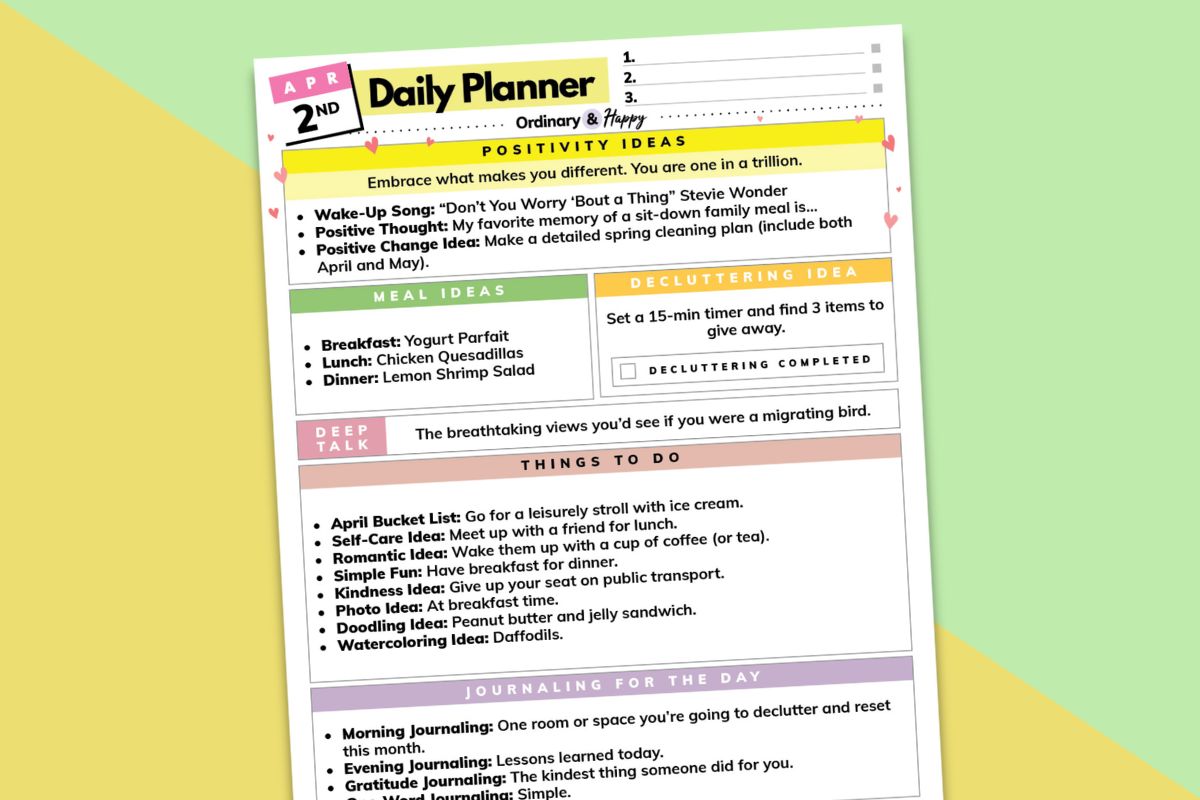 april 2nd daily planner tilted to the left on a yellow and green background